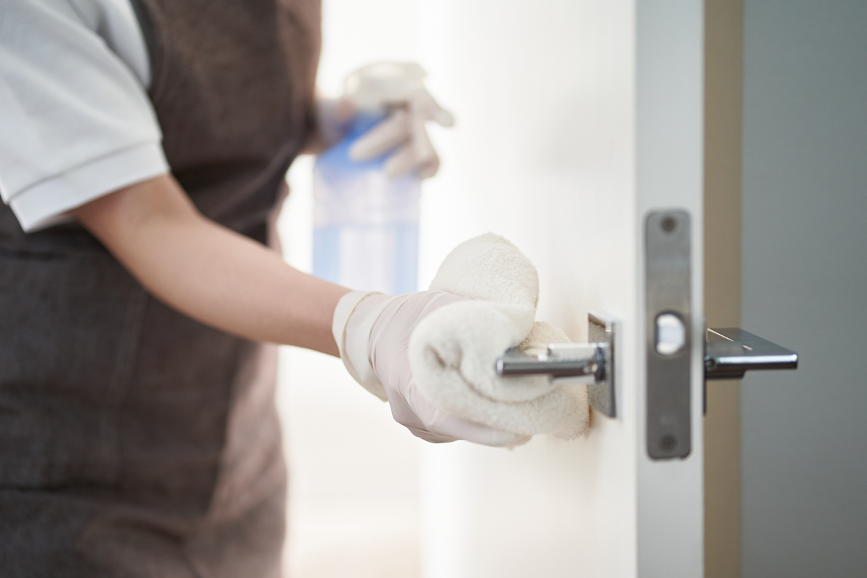 woman commercial cleaning door handle